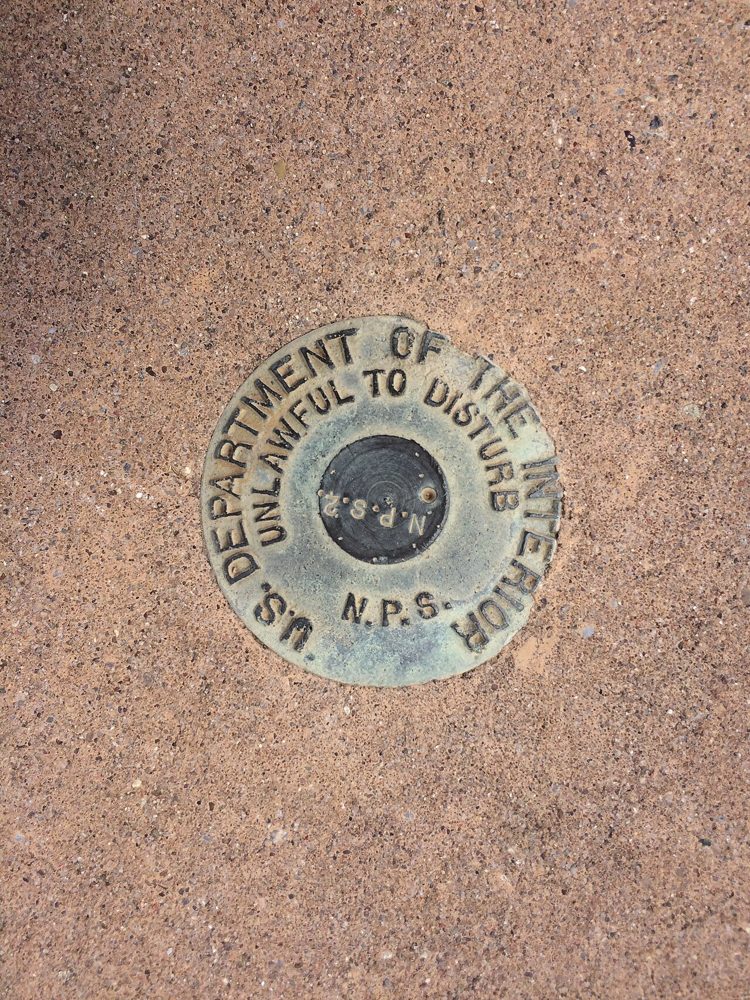 A round metal survey disk stamped U.S. Department of the Interior, set at Chamizal National Memorial in El Paso, Texas